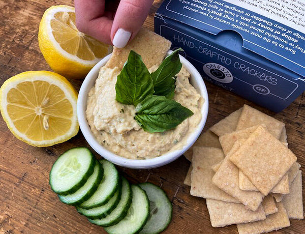 Onesto gluten-free, vegan, wheat-free sea salt crackers with creamy homemade hummus. 